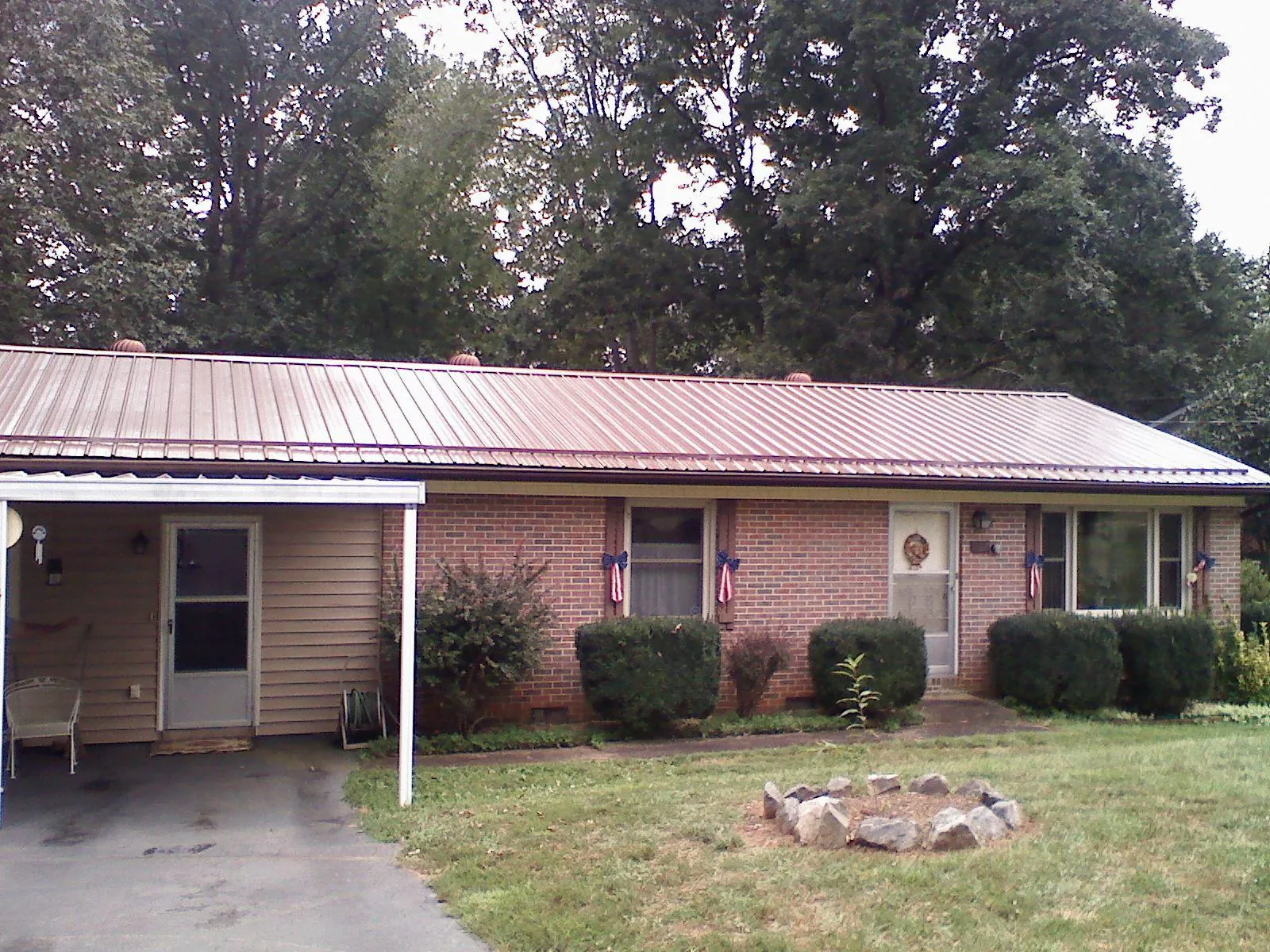 Bronze metal roof and carport on a brick ranch home — Roof Repair work by our crew in Cherry Hill